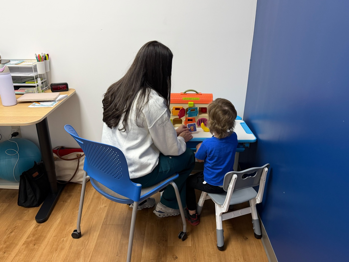 A Speak Easy Clinics therapist working with a child during a session